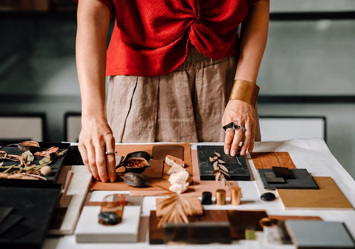 A designer laying out the materials for a design